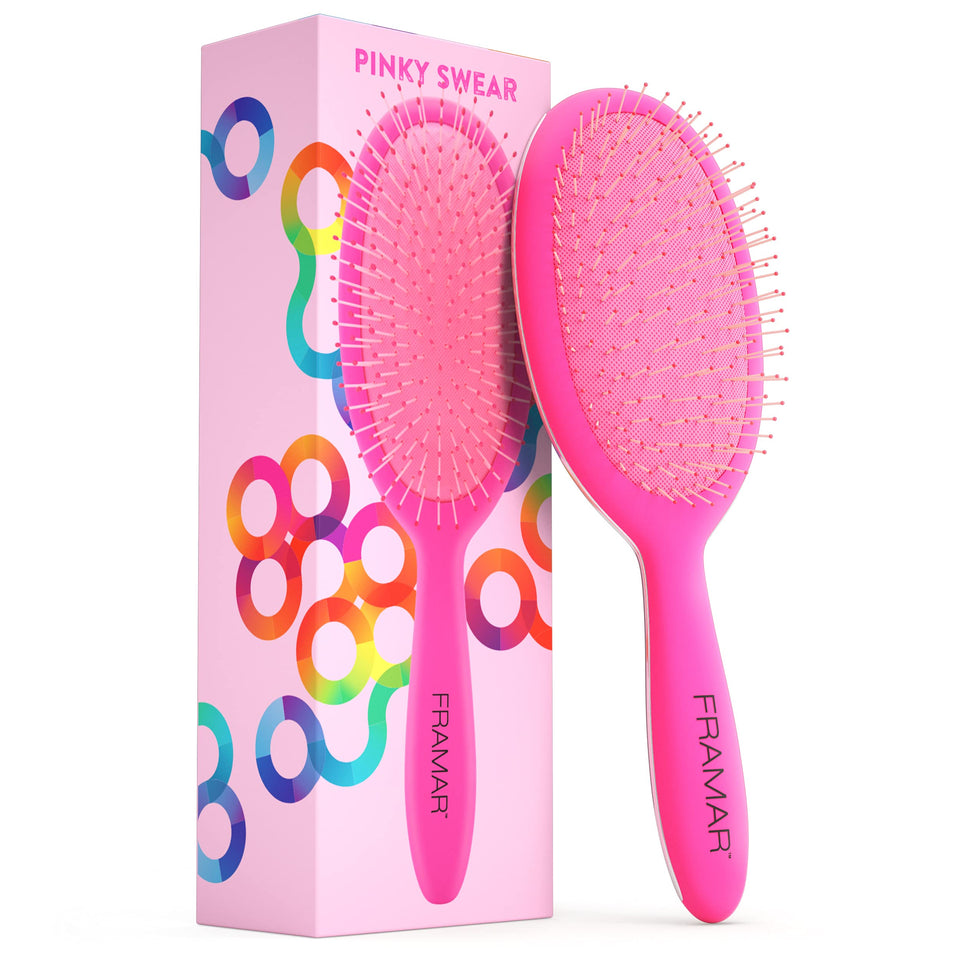 FRAMAR detangling brush for curly hair in pink glides through curls with minimal breakage.