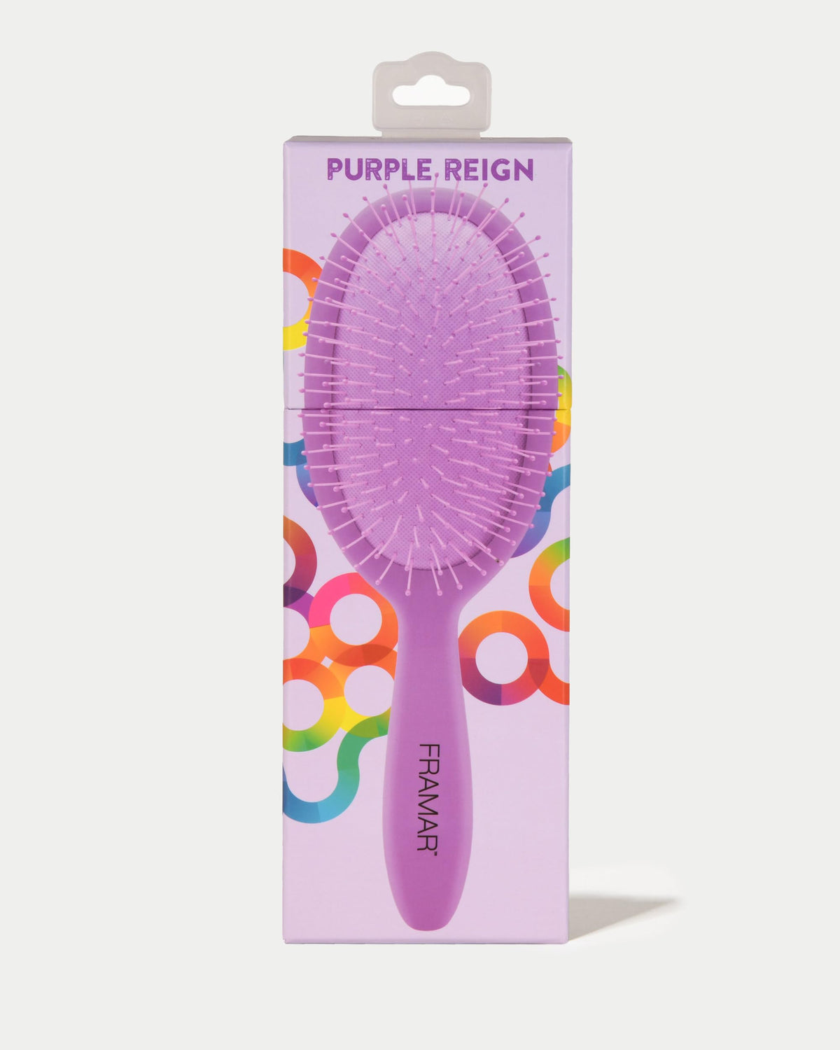 Ergonomic grip handle on FRAMAR detangling brush for secure brushing