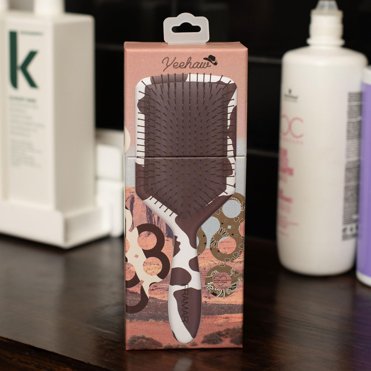 Framar paddle detangler cow-print detail shot showcases stylish portable hair tool.