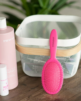 FRAMAR pink detangling brush design adds style to daily hair care.