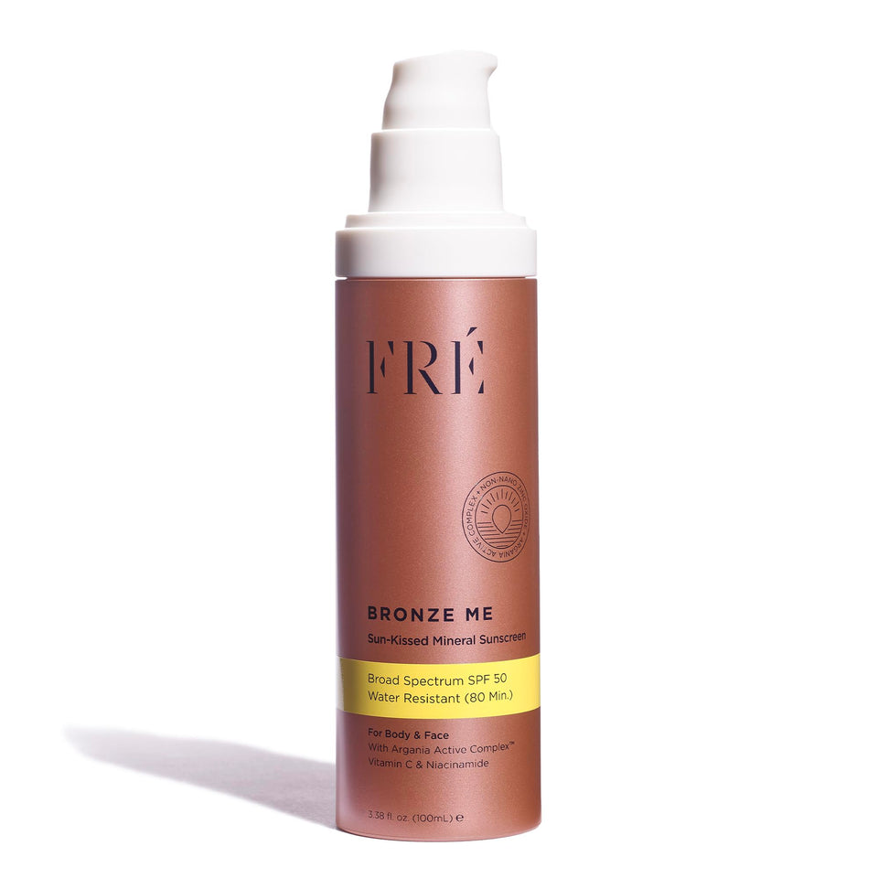 FRÉ Bronze Me SPF 50 bottle cap showing tinted sunscreen and glow