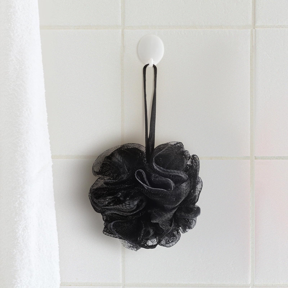 Funnymoom black and white loofah—stylish bathroom decor and exfoliation.