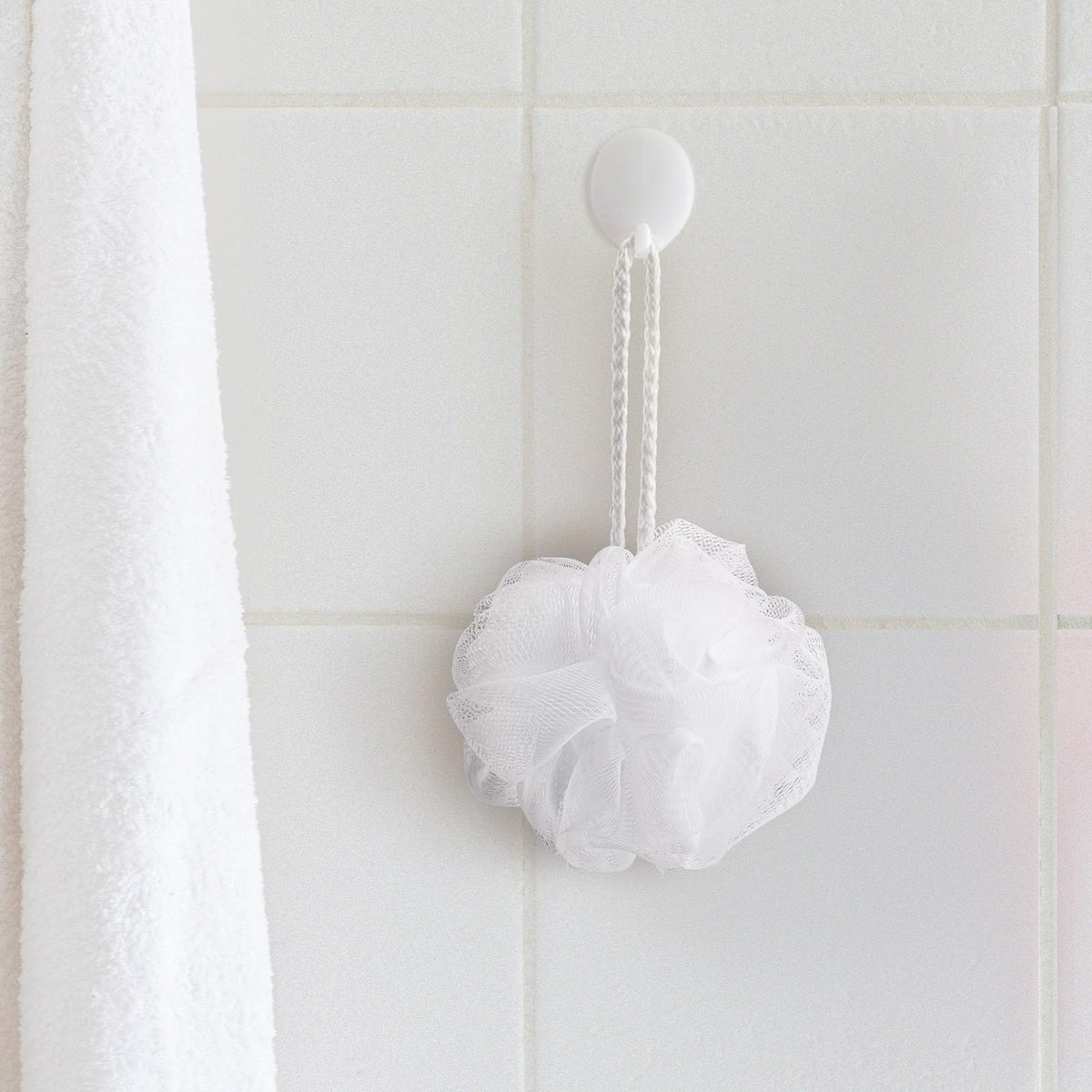 Funnymoom white loofah made of PE material offers soft, durable cleansing.