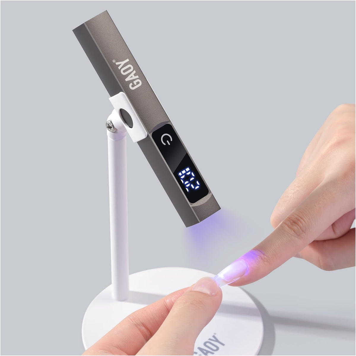 GAOY handheld matte-black nail lamp enables precise one-nail cures.