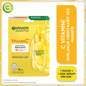 Garnier Vitamin C sheet mask on face for cooling hydration.