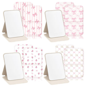 Geelin pink bow compact mirror outside cover for on-the-go touchups.