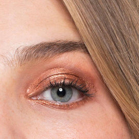 Gen See Bronze Age swatch on skin highlights rich, reflective color.
