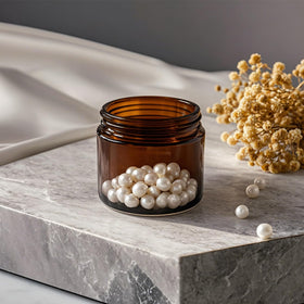 Generic amber glass jar for cosmetics storage, keeps creams organized at home.