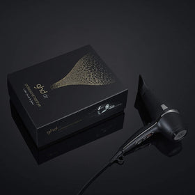 ghd Air Hair Dryer in use with diffuser-style attachment for soft volume.