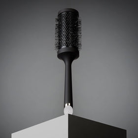 ghd brush in use on long hair delivering smooth blowouts