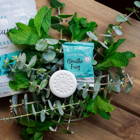 Gilden Tree shower steamer tablet in a cozy bathroom scene.