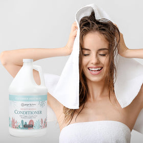 Bottle with mint leaves suggests natural conditioning ingredients from Ginger Lily Farms Botanicals