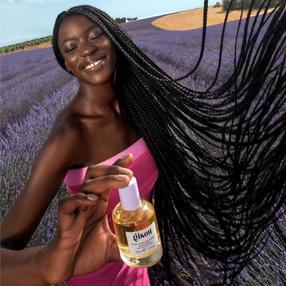 Gisou Honey Infused Hair Perfume being applied to hair for light refresh.