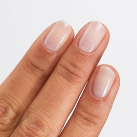 Hand applying No. 114 Pink Sheen for at-home manicure.
