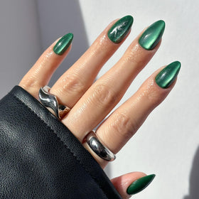 Glamnetic Slytherin velvet green nails with snake graphic for bold wizard-inspired style.