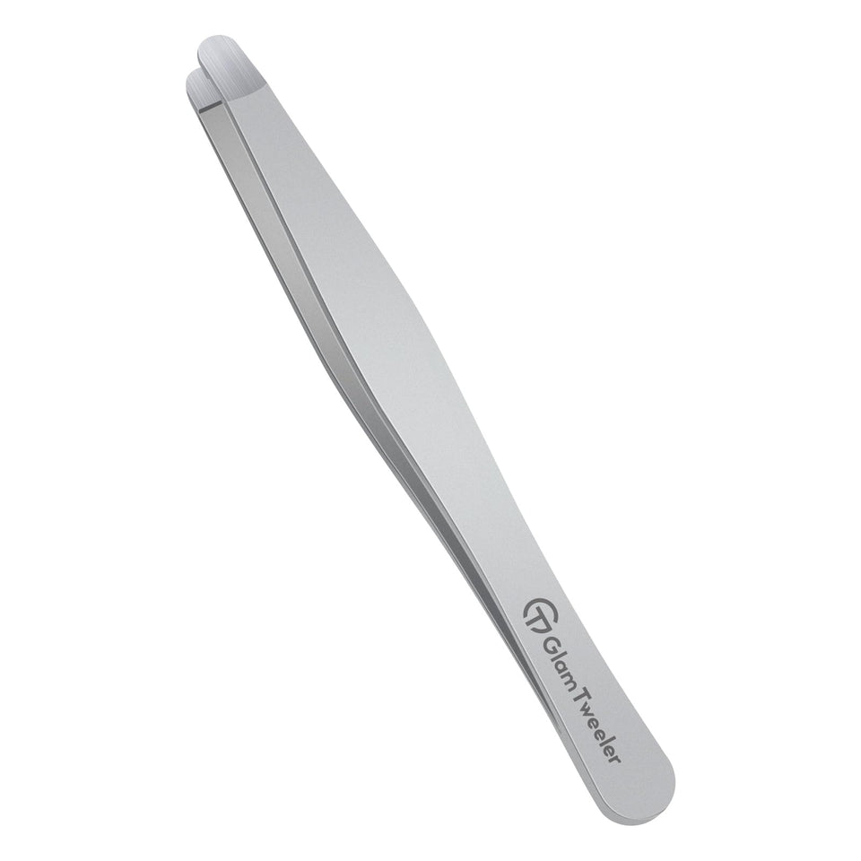 GlamTweeler premium tweezers with rounded tip close-up for gentle hair removal on the brow line.