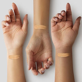 Glo Skin Beauty Luminous Liquid Foundation Naturelle bottle on the skin shows dewy finish.