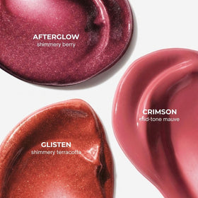 Glossier Afterglow swatch shows berry shade with champagne shimmer