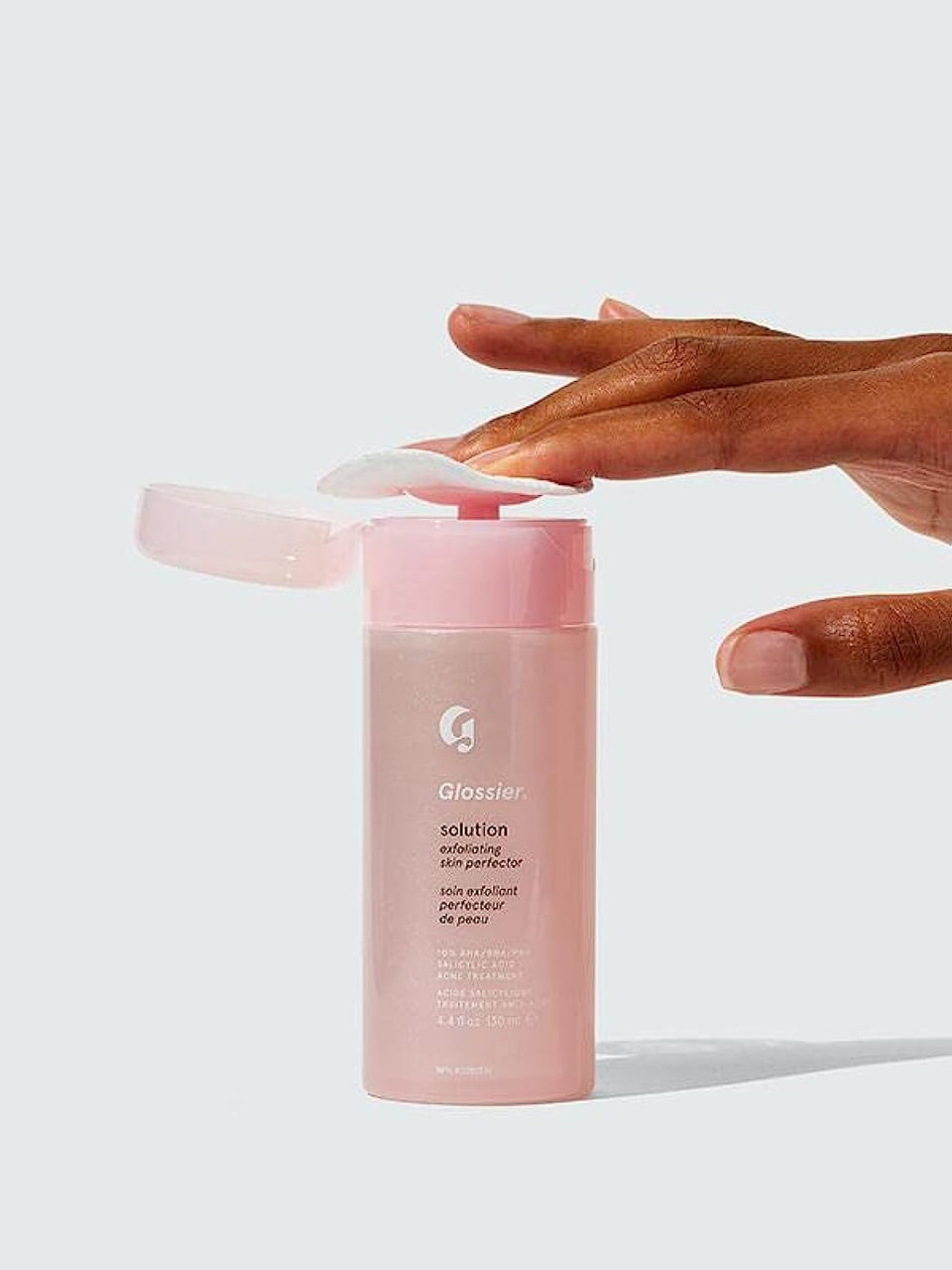 Glossier Solution bottle close-up showing smoother texture and radiant skin.