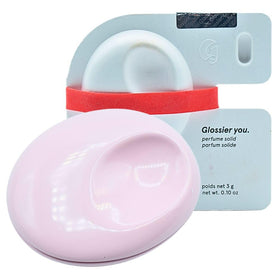 Glossier You Solid Perfume compact closeup highlighting refillable design for on-the-go scent.