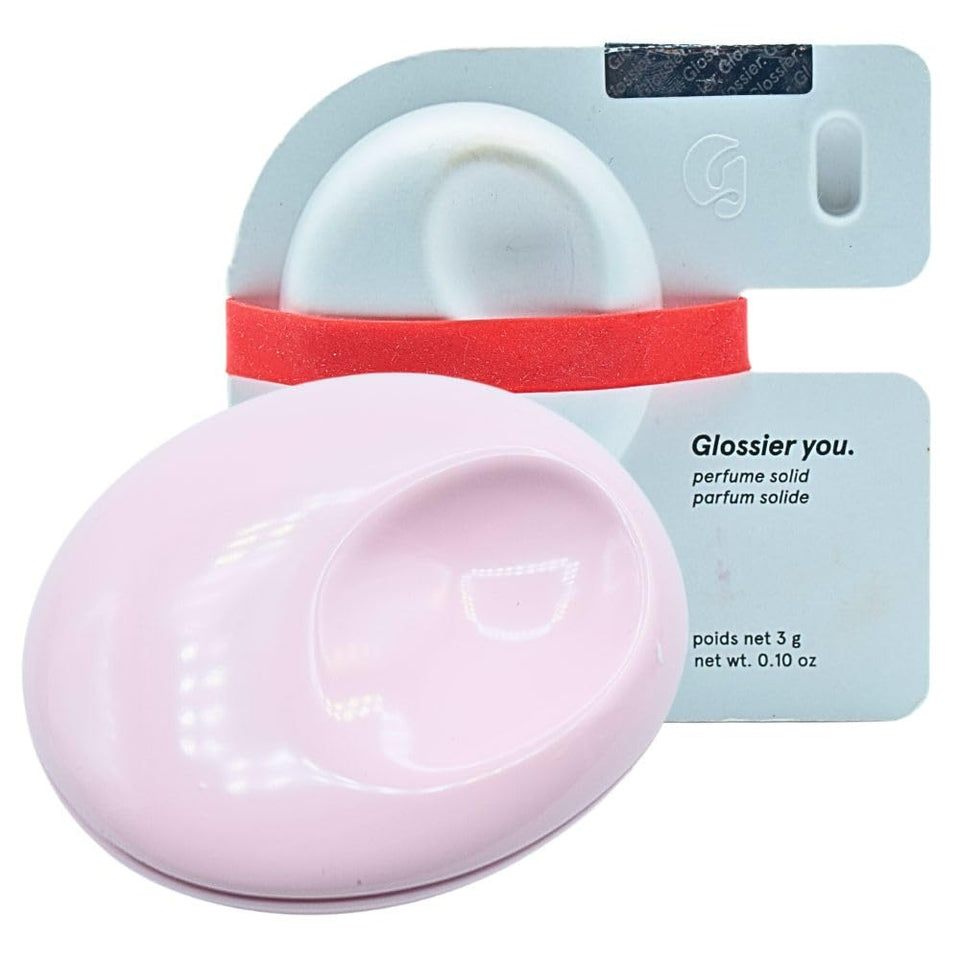 Glossier You Solid Perfume compact closeup highlighting refillable design for on-the-go scent.