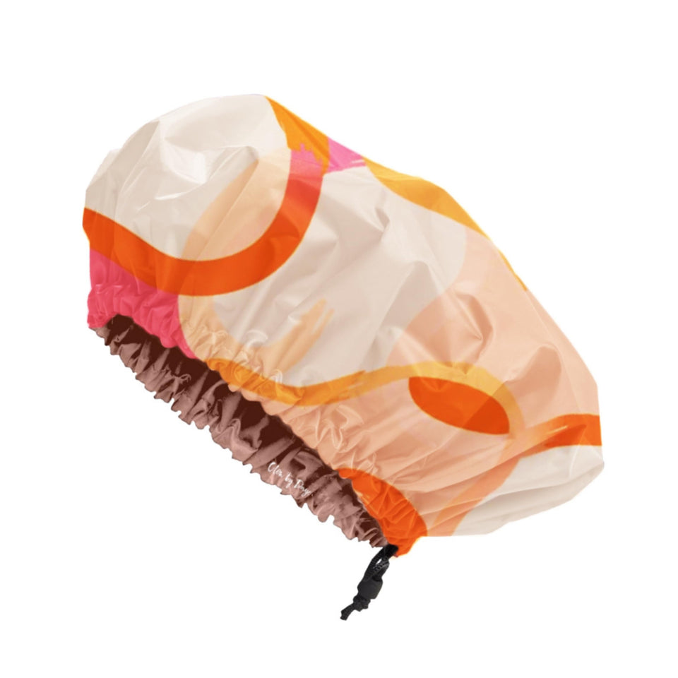 Glow by Daye satin-lined shower cap with adjustable drawstring protects hair from moisture during showers.