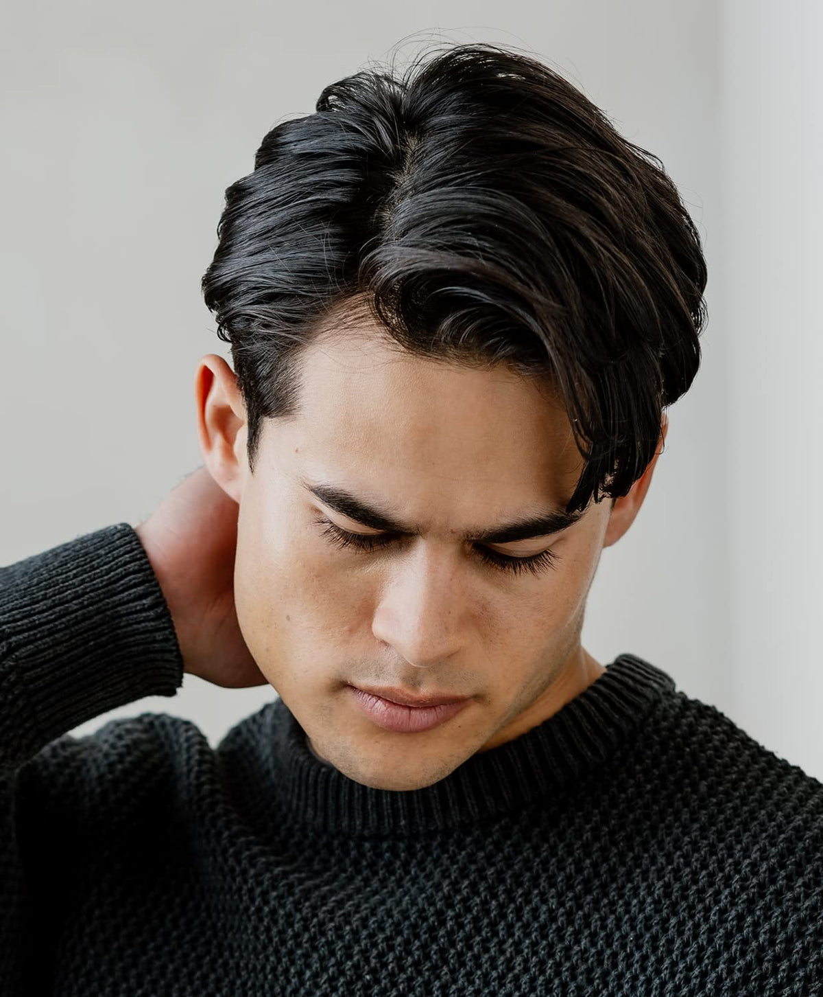 GO247 Grooming Cream hands rubbing together to apply evenly for controlled styling.