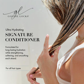 Applying Goldie Locks conditioner to hair for smooth detangling.