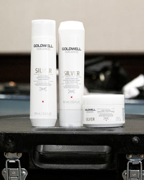 Hands lather Goldwell Dualsenses Silver Shampoo to distribute care evenly