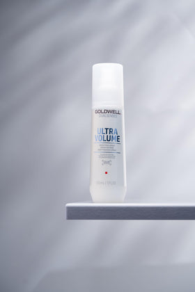 Goldwell Dualsenses Ultra Volume Bodifying Spray label closeup indicating lightweight detangling properties.