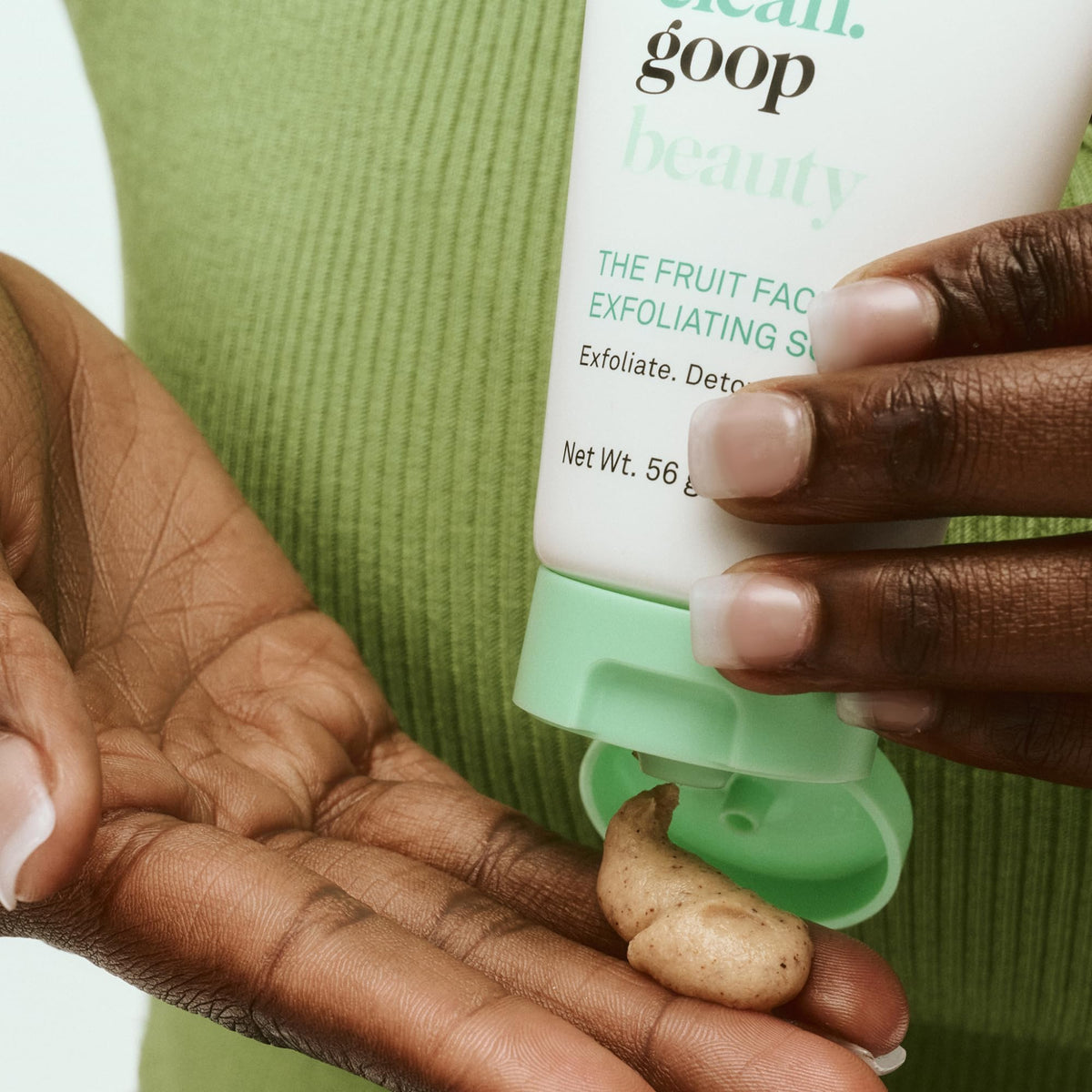 Applying Good Clean Goop Fruit Facial Scrub onto wet skin during cleansing.