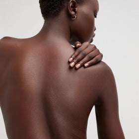 Goop Beauty Body Butter applied on skin, demonstrating visible hydration