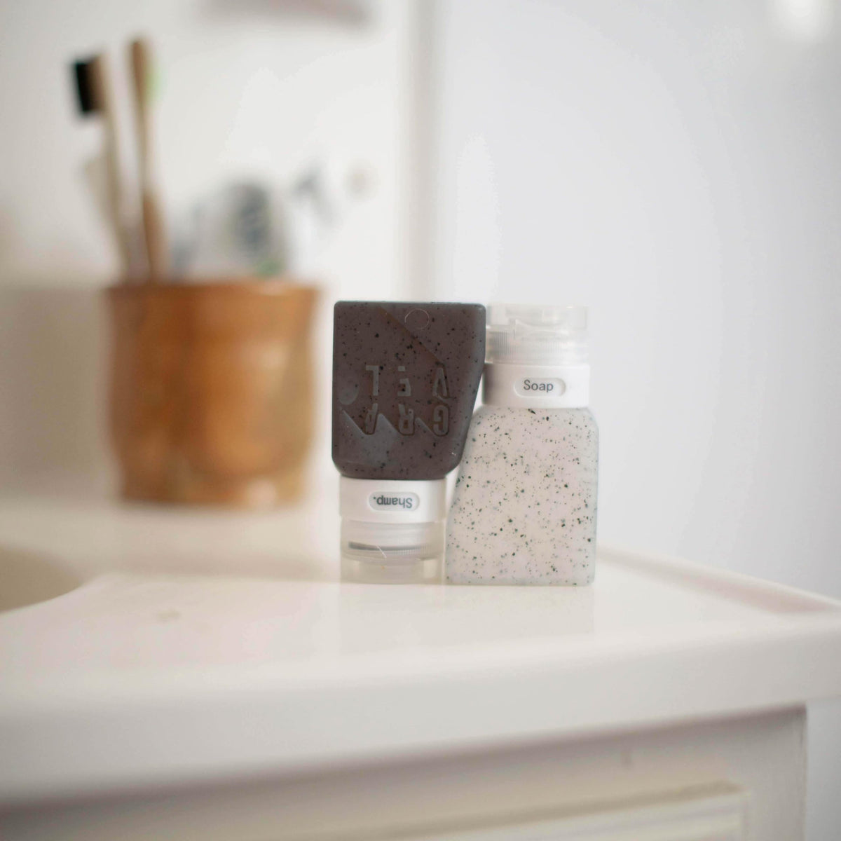 Gravel travel bottles set with clear bag highlighting organized toiletry kit.