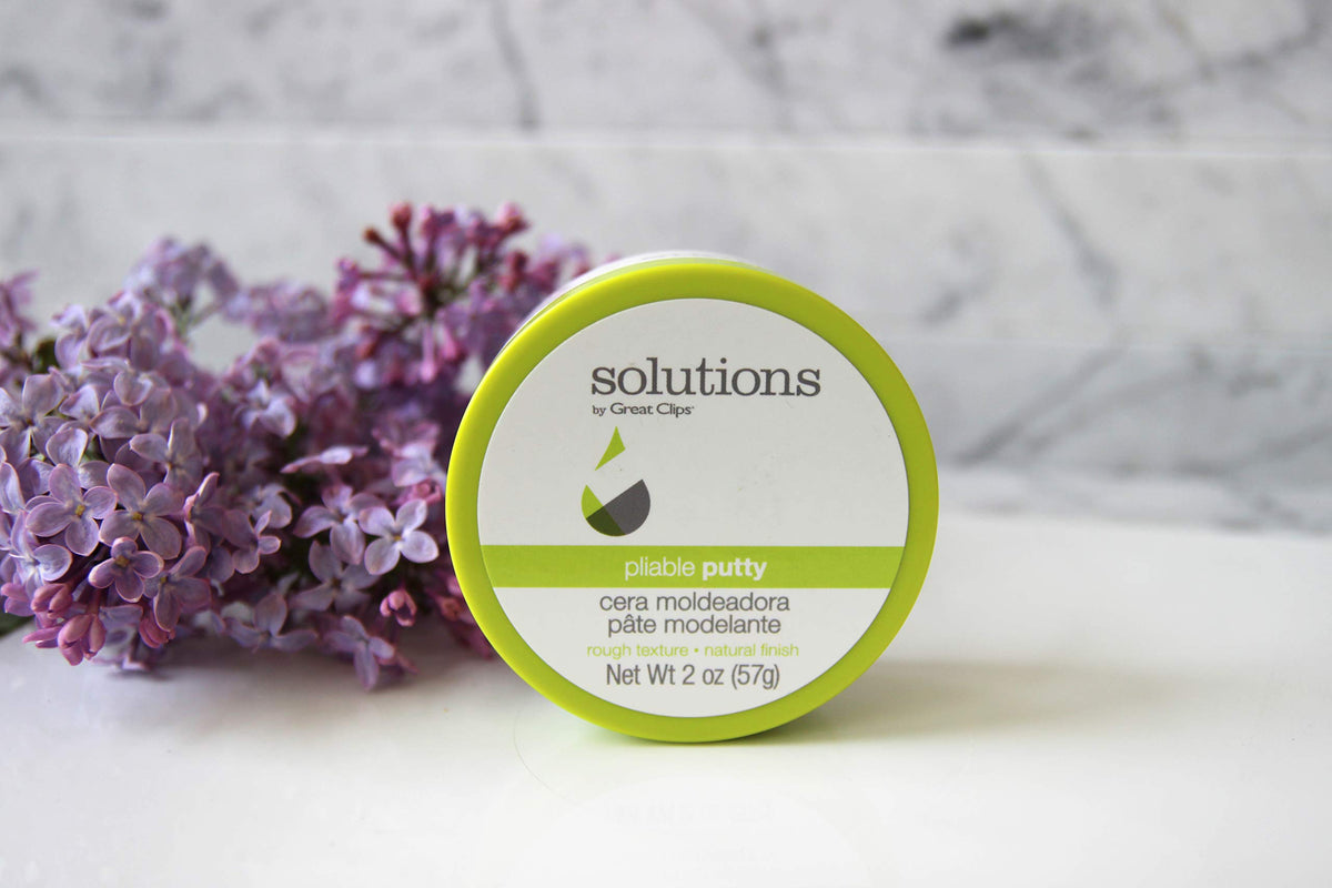 Hands applying Great Clips Pliable Putty for quick texture and controlled shine
