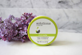Hands applying Great Clips Pliable Putty for quick texture and controlled shine