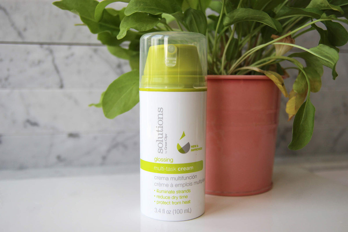 GREAT CLIPS Glossing Multi-Task Cream smoothing hair for a polished look.
