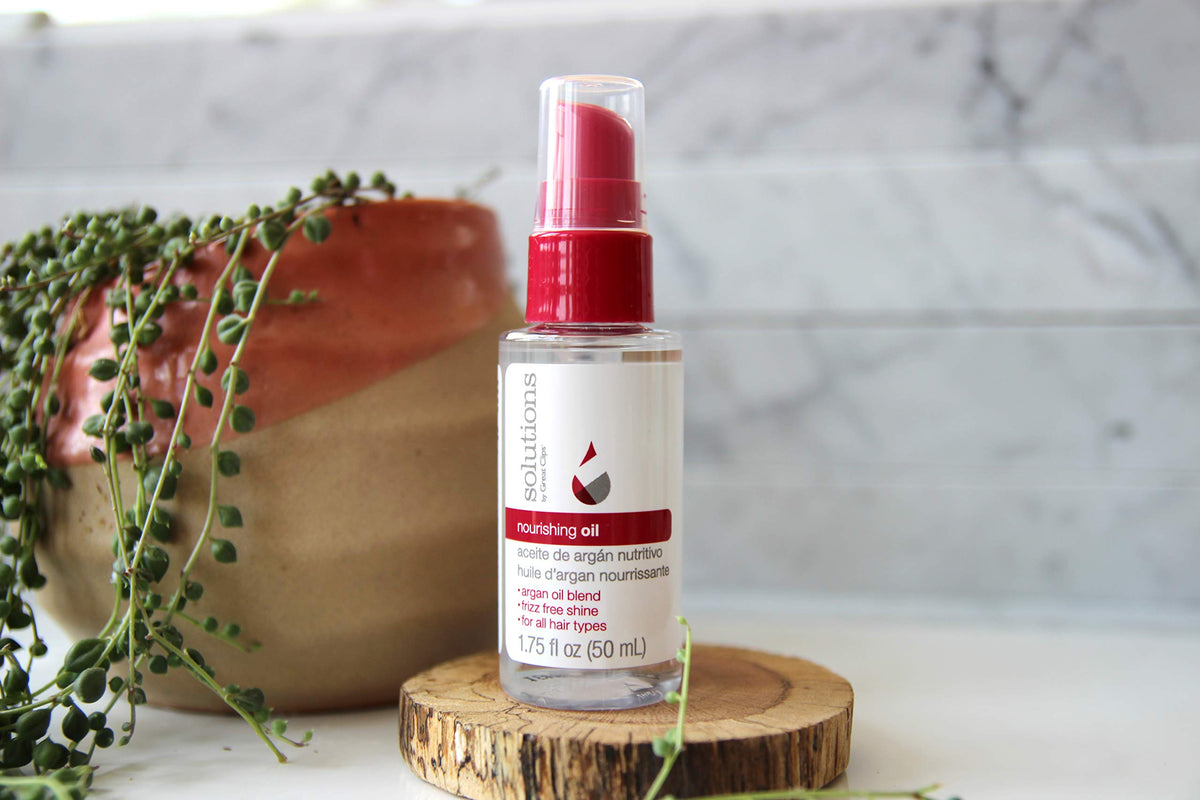 GREAT CLIPS Nourishing Oil pump demonstrates quick absorption for frizz control.