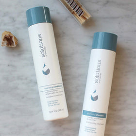 Great Clips Solutions Volumizing Shampoo label closeup highlights daily cleansing