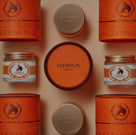 Guerisson 9 Complex Cream 70 g jar on a vanity display.