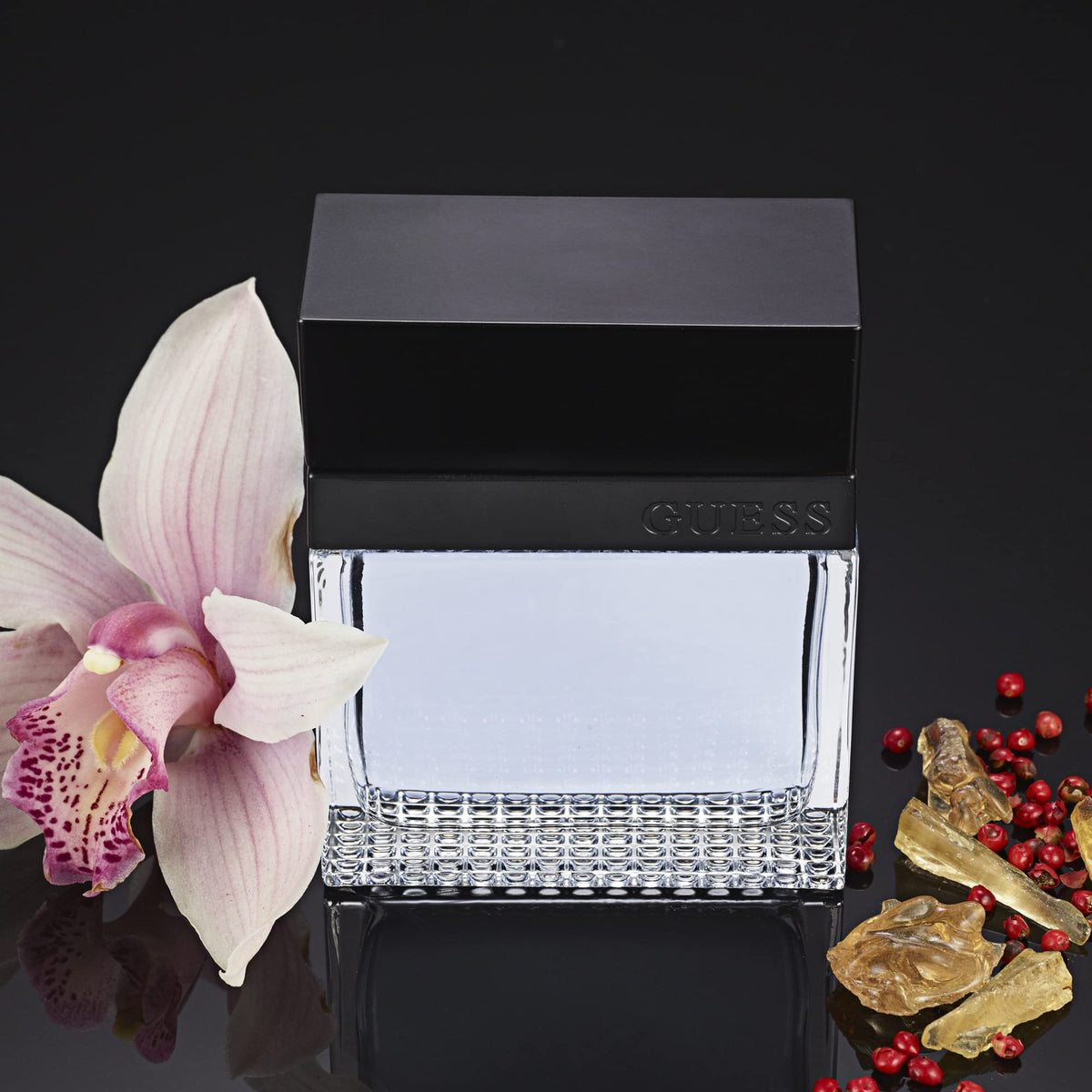 Base notes panel with GUESS Seductive Homme amberwood and sandalwood warmth.