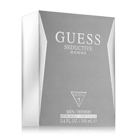 Store display featuring GUESS Seductive Homme bottle and packaging.