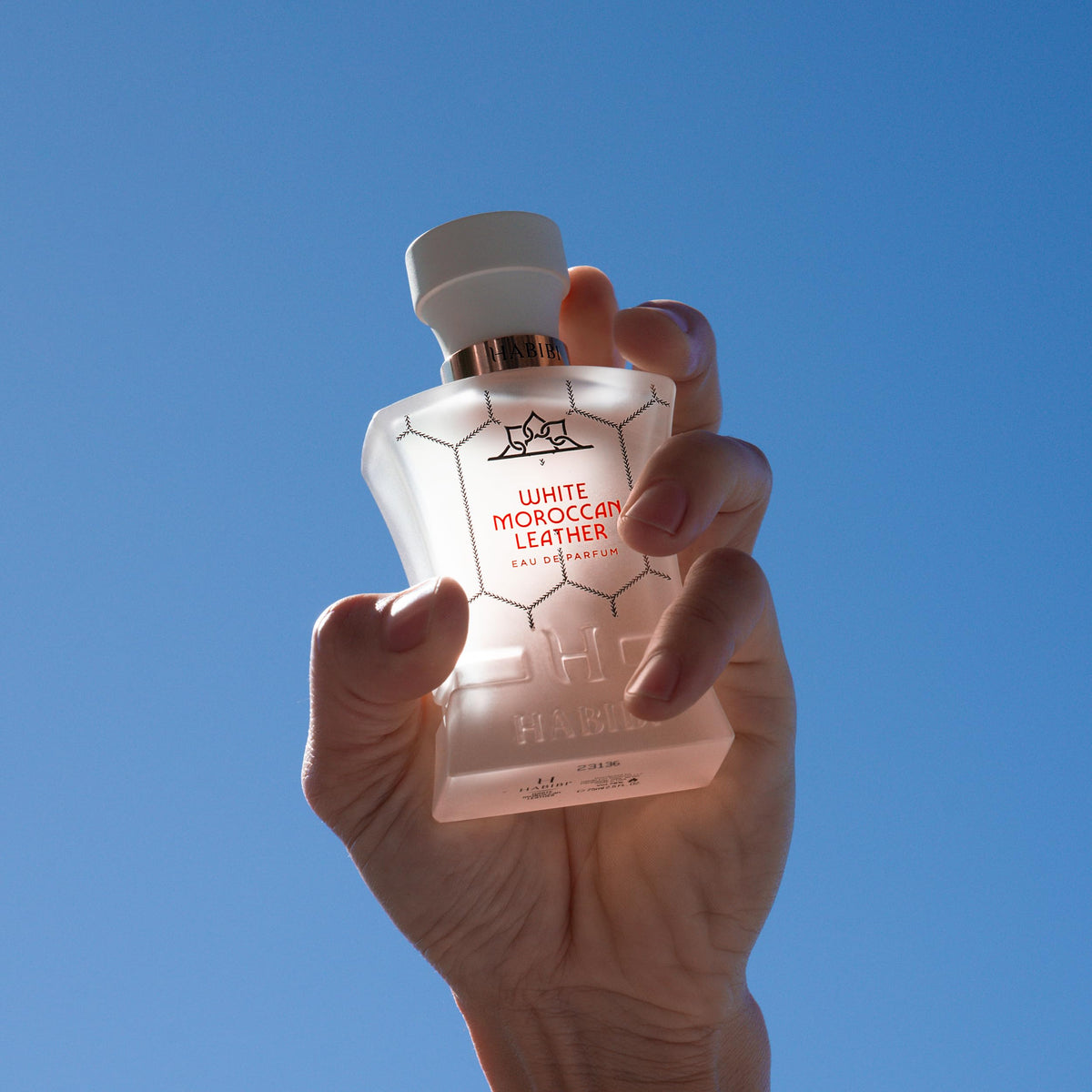 H HABIBI White Moroccan Leather bottle on display highlighting long-lasting scent.