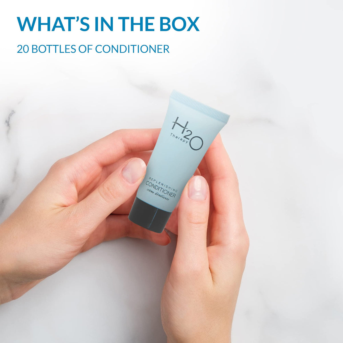 H2O Therapy travel-size conditioner in hotel bathroom offers a spa-like feel with fresh scent.
