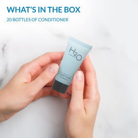 H2O Therapy travel-size conditioner in hotel bathroom offers a spa-like feel with fresh scent.