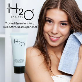 H2O Therapy travel-size conditioner ideal for vacation rentals, keeping bathrooms stocked.