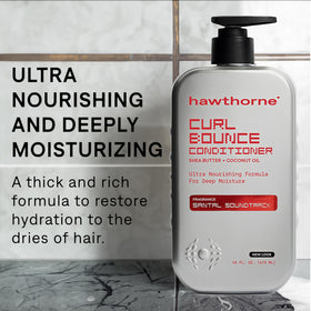 Close-up of creamy texture ready to detangle and hydrate curls.