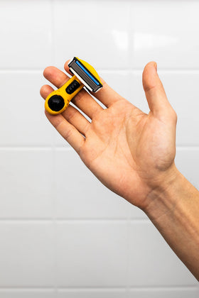 Integrated system with finger ring and ball for safety in shaving.