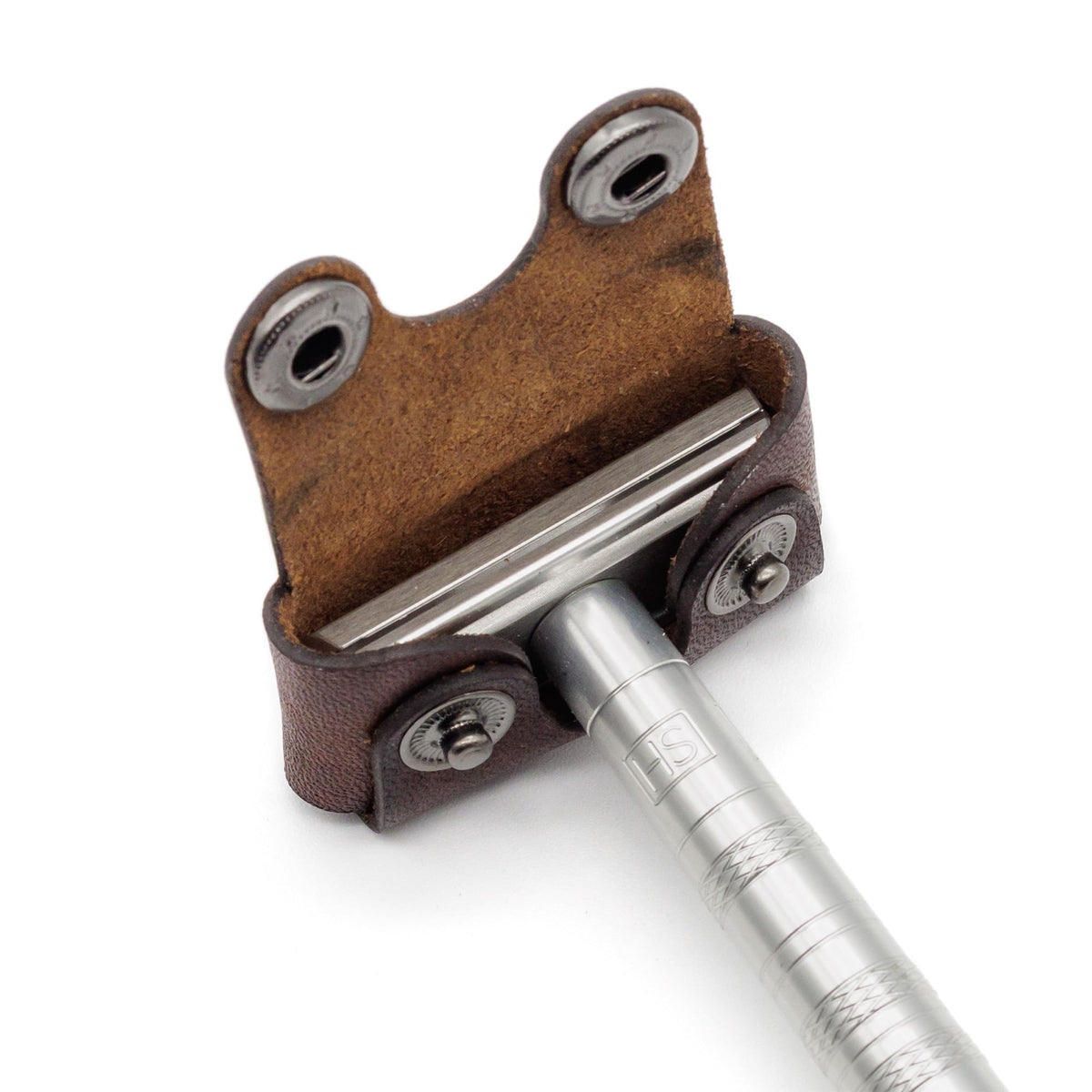 Henson Shaving leather head cover on razor, preserves portability and quick access.