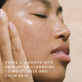 HERBIVORE Emerald Facial Oil ashwagandha-root imagery, suggesting balancing calm amid busy days.