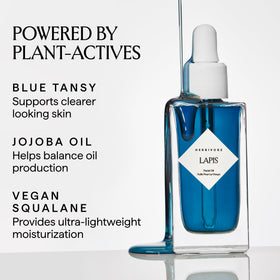 HERBIVORE Lapis Blue Tansy Oil bottle closeup highlighting Azulene